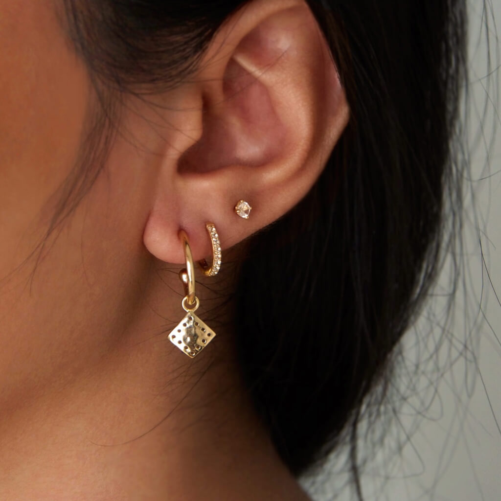 Murkani Petites 11mm Hoop Earrings With White Topaz In 18 KT Yellow Gold Plate